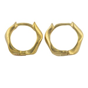 May include: A pair of gold hoop earrings with a unique, textured, geometric design.