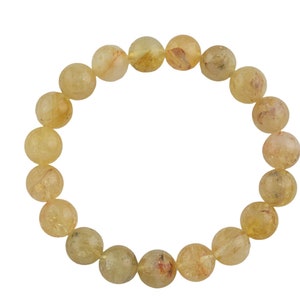 May include: A bracelet made of round, light yellow beads with a subtle golden shimmer.