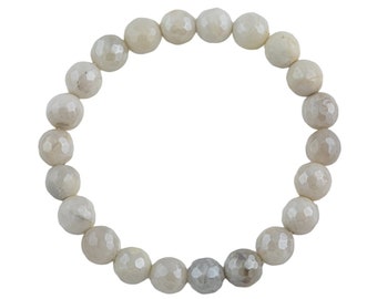 May include: A white gemstone bracelet with faceted beads.