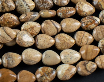 May include: A strand of brown and beige gemstone beads with a smooth, polished finish. The beads are teardrop shaped and have a natural, earthy look.