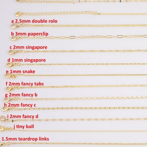 May include: A close-up of 13 different gold chain styles, each labeled with a letter and a description of the chain type and size in millimeters. The chains are arranged in rows on a white background.