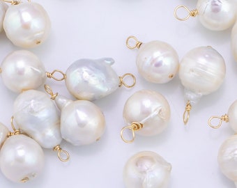 May include: A collection of white baroque pearl charms with gold-toned jump rings. The pearls are various shapes and sizes.
