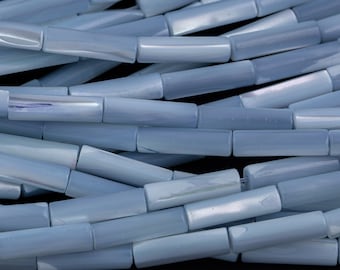 May include: A strand of light blue, iridescent, shell beads. The beads are cylindrical in shape and have a smooth, polished finish.