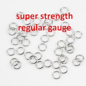 May include: A pile of silver jump rings, labeled "super strength regular gauge".