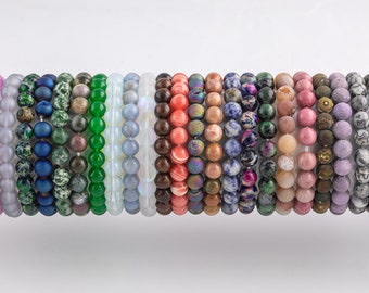 May include: A collection of 20 colorful beaded bracelets made with various natural stones, including amethyst, jade, and lapis lazuli.