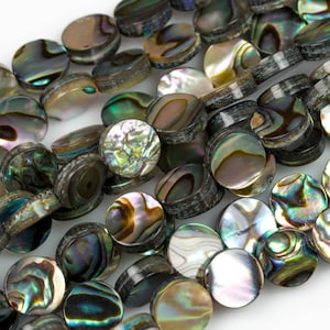 May include: A strand of iridescent abalone shell beads, each bead is a round disc with a dark grey edge and a shimmering, multi-coloured interior.