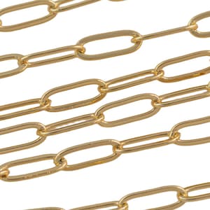 May include: A close-up of a gold chain with oval links. The chain is made of metal and has a shiny finish.