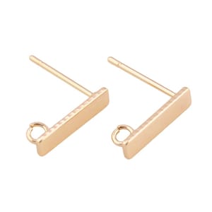 May include: Two gold-toned earring posts with a rectangular bar and a small loop at the end. The posts are designed to be used with a variety of earring charms.