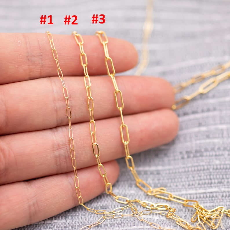 May include: Three gold-colored chain necklaces with different link styles are displayed. The chains are labeled #1, #2, and #3. The chains are shown against a neutral background.