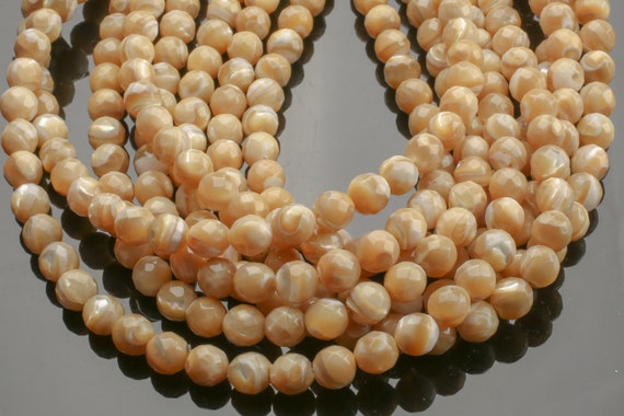 thumbnail interactive-video image 1 of 12mm Natural White Shell Pearl Faceted Round Loose Beads – 15 Inch Strand 1 of 5
