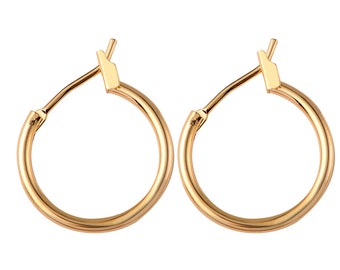 May include: A pair of gold hoop earrings. The earrings are simple and classic, with a smooth finish.