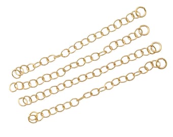 May include: Four gold chains with jump rings at each end. The chains are arranged in a staggered pattern.