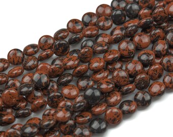 May include: A strand of brown and black speckled round gemstone beads. The beads are smooth and polished.