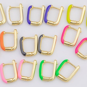 May include: Gold-tone square hoop earrings with colorful enamel accents. The earrings feature a variety of colors, including white, blue, yellow, pink, orange, black, and green. Each earring has a hinged closure.