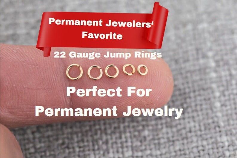 May include: Five gold jump rings of different sizes on a finger. The rings are 22 gauge and are labeled "Permanent Jewelers' Favorite" and "Perfect For Permanent Jewelry".