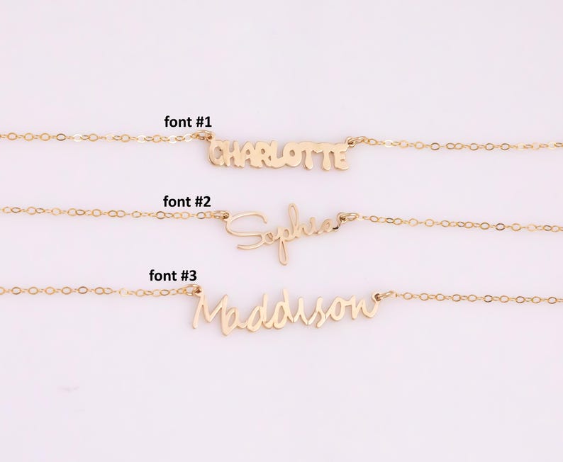 May include: Three gold necklaces with different fonts for the names Charlotte, Sophia, and Maddison. The necklaces are on a white background.
