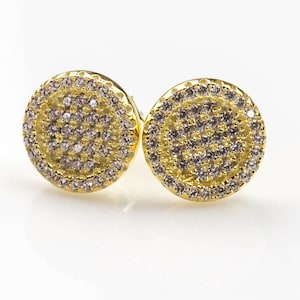 May include: A pair of gold round stud earrings with a double row of small clear cubic zirconia stones.