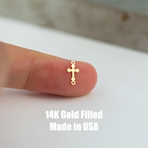 May include: A small gold-filled cross charm with two jump rings. 14K Gold Filled Made in USA.