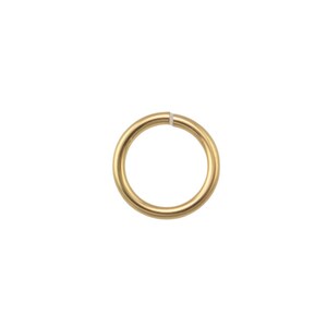 May include: A single, gold-colored jump ring, isolated on a white background. The ring is circular with a small opening, likely for jewelry making or crafts. The metal has a smooth, polished finish.