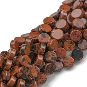 May include: A strand of round, red and black jasper beads. The beads are smooth and polished, with a speckled pattern.