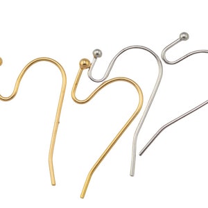May include: Three earring hooks, one gold, one silver, and one silver with a gold ball at the top.