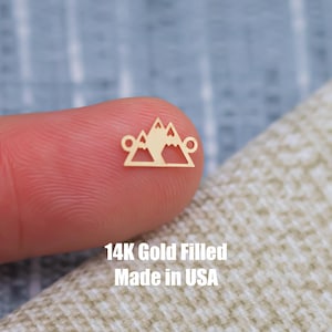 May include: Gold-filled mountain charm with two jump rings. 14K Gold Filled Made in USA.