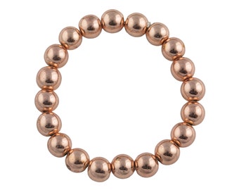 May include: A rose gold beaded bracelet with round beads.