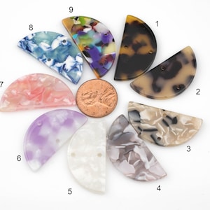 May include: Nine half-circle shaped resin pieces with different patterns and colors. The pieces are arranged in a circle with a penny in the center.