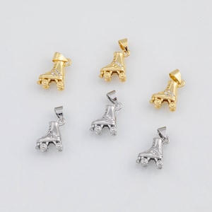 May include: Gold and silver roller skate charms. The charms are detailed with small wheels and decorative accents. The roller skates are shown from a side view, with a loop at the top for attaching to a necklace or bracelet.