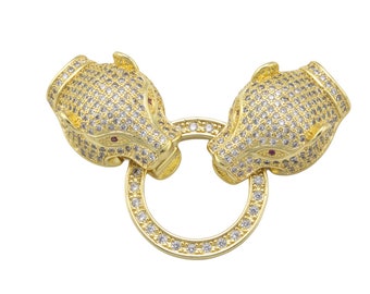 May include: Gold-tone chain clasp with two animal head ends, each with a red stone eye and covered in clear rhinestones.