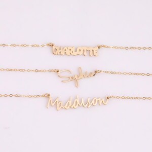 May include: Three gold necklaces with the names Charlotte, Sophia, and Madison written in cursive script.
