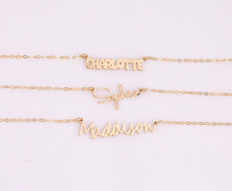 May include: Three gold necklaces with the names Charlotte, Sophia, and Madison written in cursive script.