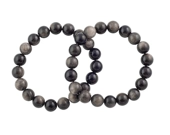 May include: Two black beaded bracelets with silver flecks, intertwined together.