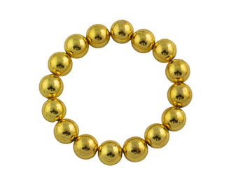 May include: A gold bracelet made of round beads.