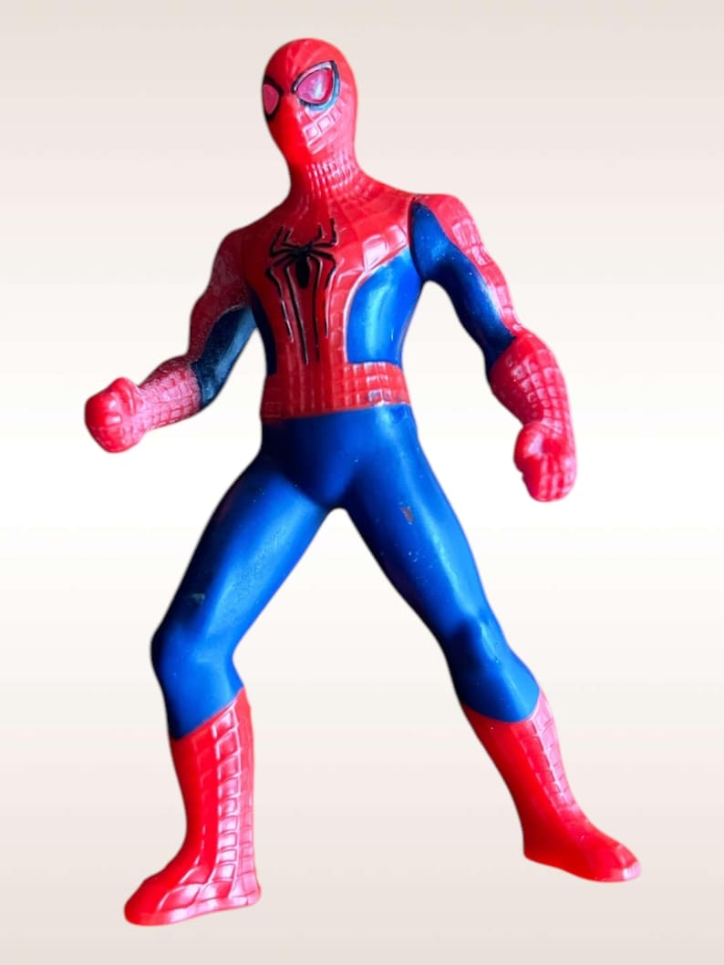 May include: A red and blue plastic action figure of Spider-Man in a fighting pose. The figure has a detailed design with a spider logo on the chest.