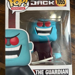 May include: A Funko Pop! vinyl figure of The Guardian from Samurai Jack, number 1055. The figure has a light blue head, red eyes, and a wide grin. The packaging includes the Funko Pop! and Samurai Jack logos.