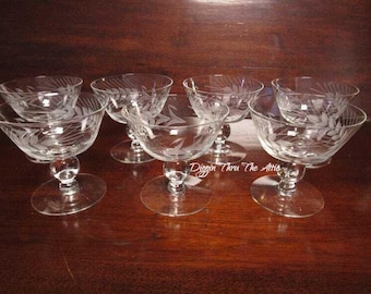 May include: Set of six clear glass stemmed dessert cups with an etched wheat design.