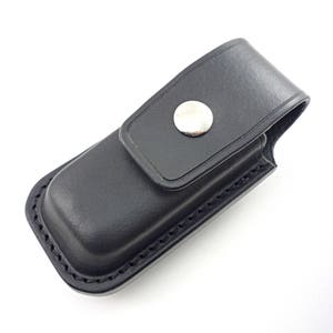 May include: Black leather case with a silver snap closure. The case is designed to hold a small pocket knife or other tool.