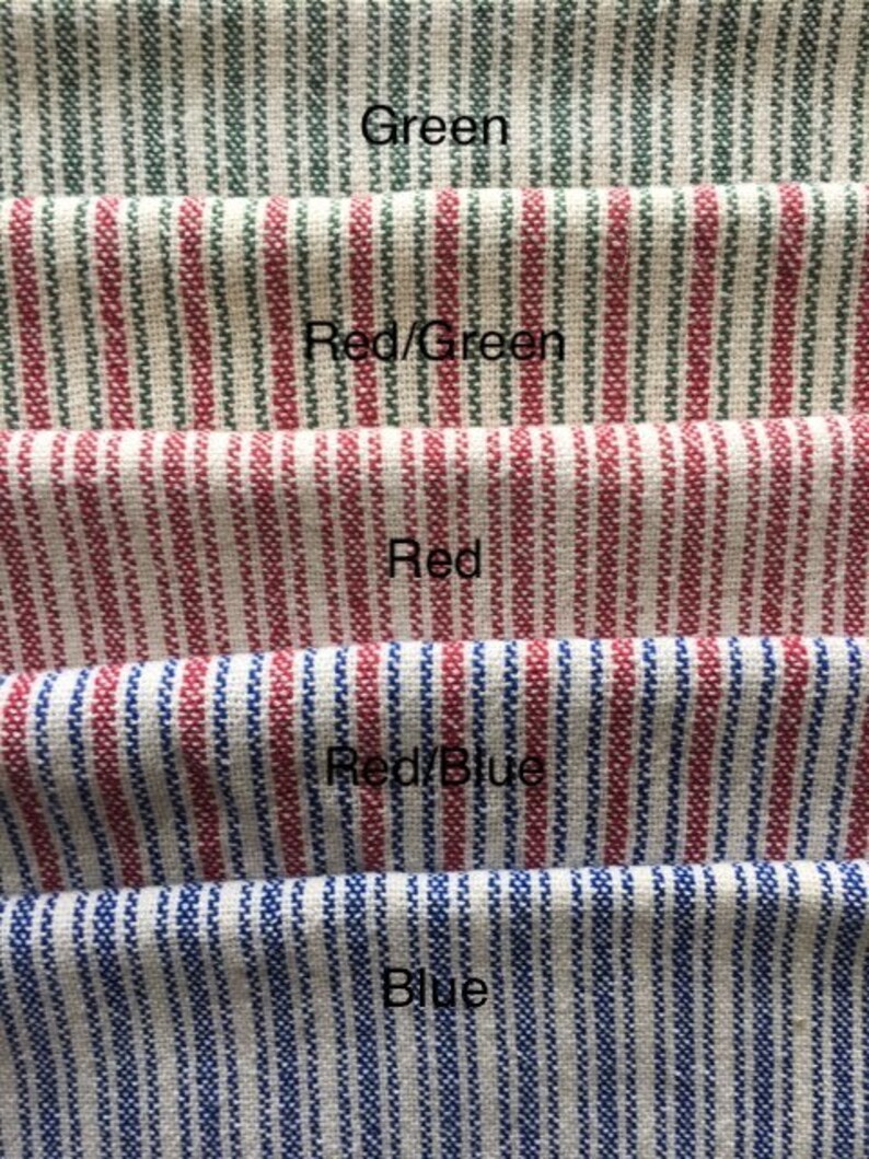 May include: Five fabric swatches with different colored stripes. The top swatch is green stripes, the second is red and green stripes, the third is red stripes, the fourth is red and blue stripes, and the bottom swatch is blue stripes.