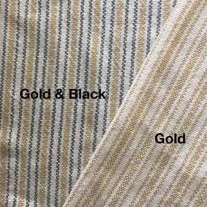 May include: Close-up of two fabric swatches. The left swatch is a striped pattern with gold and black stripes. The right swatch is a striped pattern with gold stripes. The text "Gold & Black" is written on the left swatch and "Gold" is written on the right swatch.