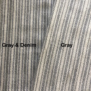 May include: Close-up of two fabric swatches with a striped pattern. The swatch on the left is labeled "Gray & Denim" and the swatch on the right is labeled "Gray".