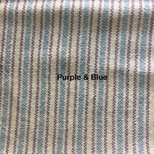 May include: Close-up of a fabric with vertical stripes in shades of purple and blue. The fabric has a woven texture.