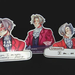 May include: Three stickers featuring a cartoon character with white hair and a red suit. The stickers have text bubbles with the following text: "Thanks to you, I am saddle with unnecessary... feelings." "I am... an ass." "Not a clown. Entire circus."