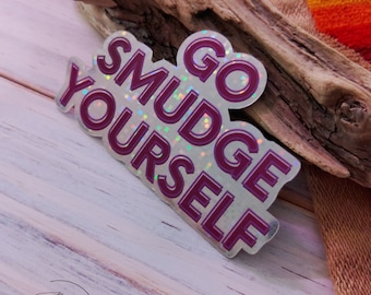 May include: A white sticker with a pink glittery design that says "Go Smudge Yourself".