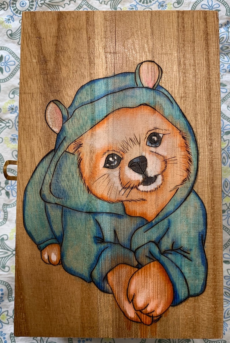 Rectangular shaped box wood birned with a puppy wearing pajamas