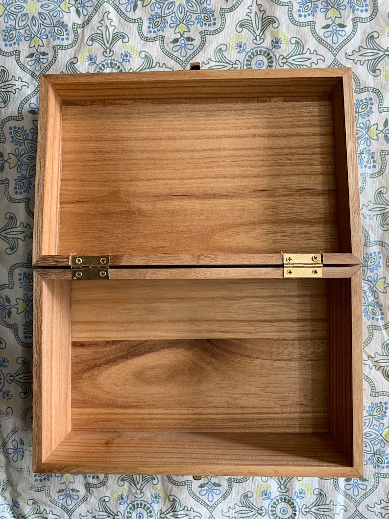 Rectangular shaped box wood birned with a puppy wearing pajamas