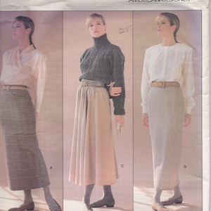 May include: A sewing pattern for a skirt and blouse by Vogue Patterns, American Designer. The pattern is for a skirt with a high waist and a blouse with a turtleneck. The pattern is by Calvin Klein and the pattern number is 1790.