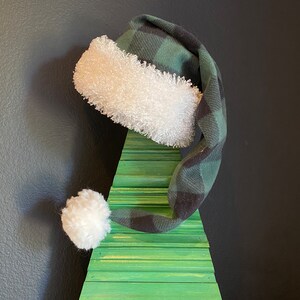 Green and Black Buffalo plaid with white furry fleece trim and 3 inch pom pom