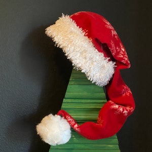 Red & White snowflake fleece with white furry fleece trim and 3 inch Pom Pom