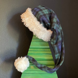 Blue/Green/Black plaid fleece with white furry fleece trim and 3 inch Pom Pom